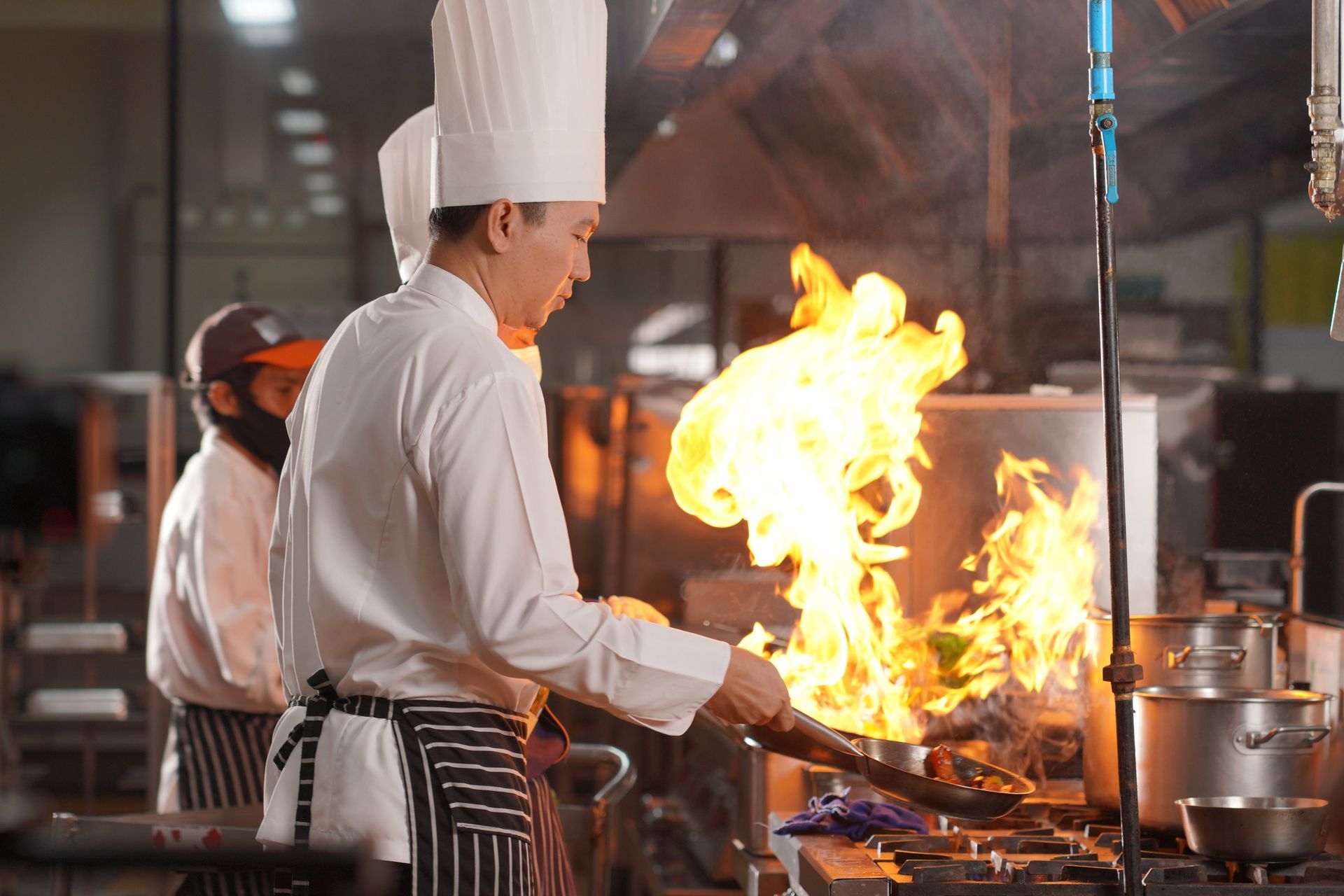 A kitchen with stainless steel appliances and white cabinets.