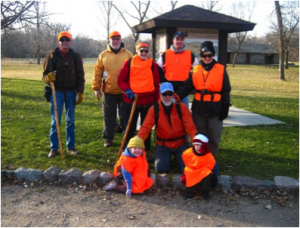 a group of people wearing orange vests are posing for a picture