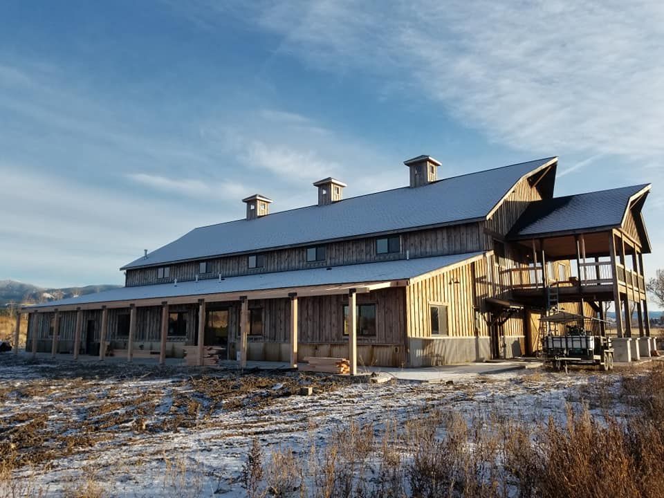 A large house with a porch and a snowy roof
