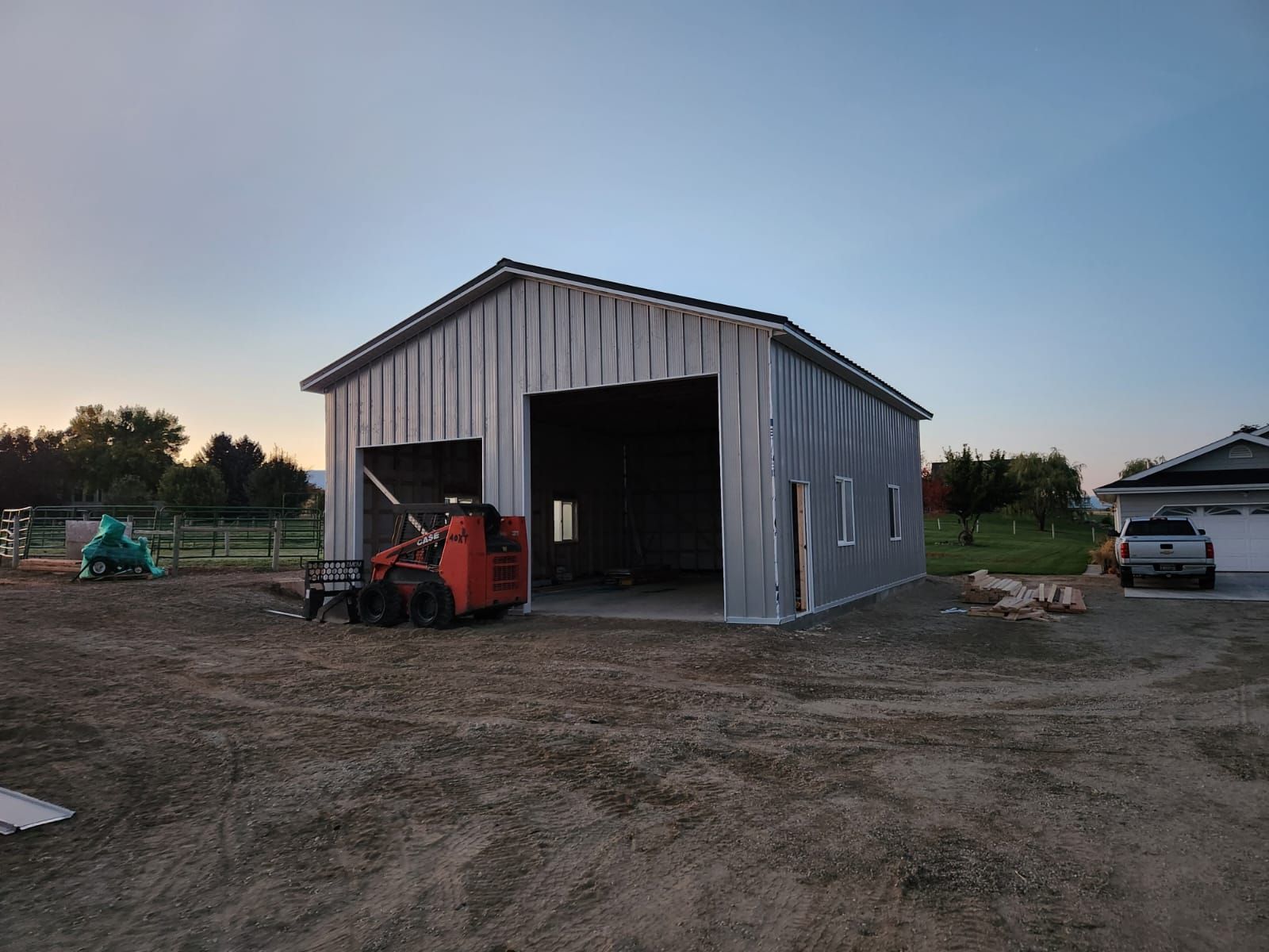 A large metal building with a tractor parked in front of it.
