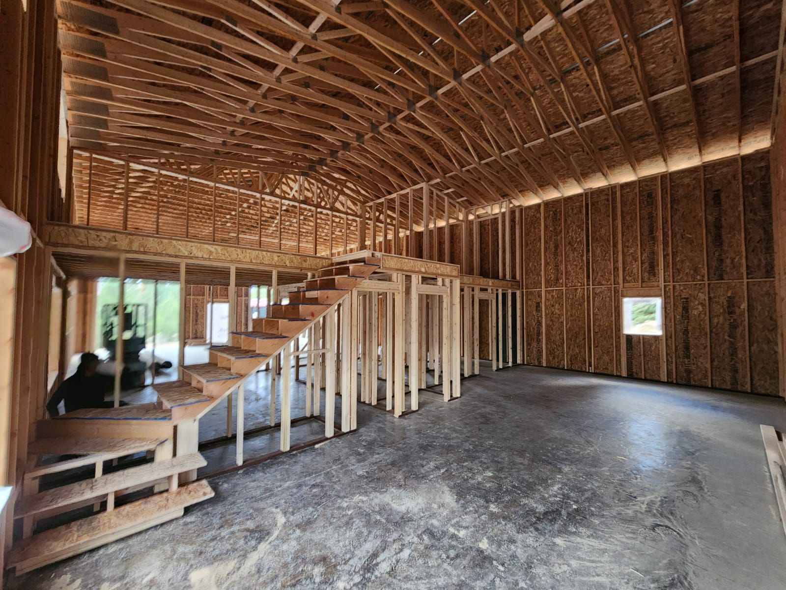 The inside of a building under construction with a staircase.