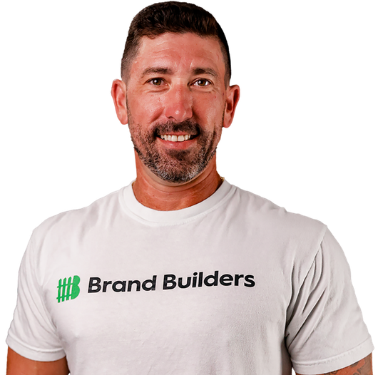 Smiling man in white Brand Builders T-shirt on a white background