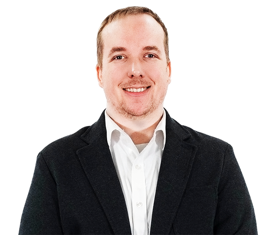 A man in a suit and white shirt smiles for the camera