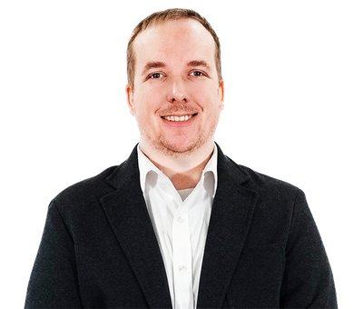 Smiling man in a black blazer and white shirt against a white background