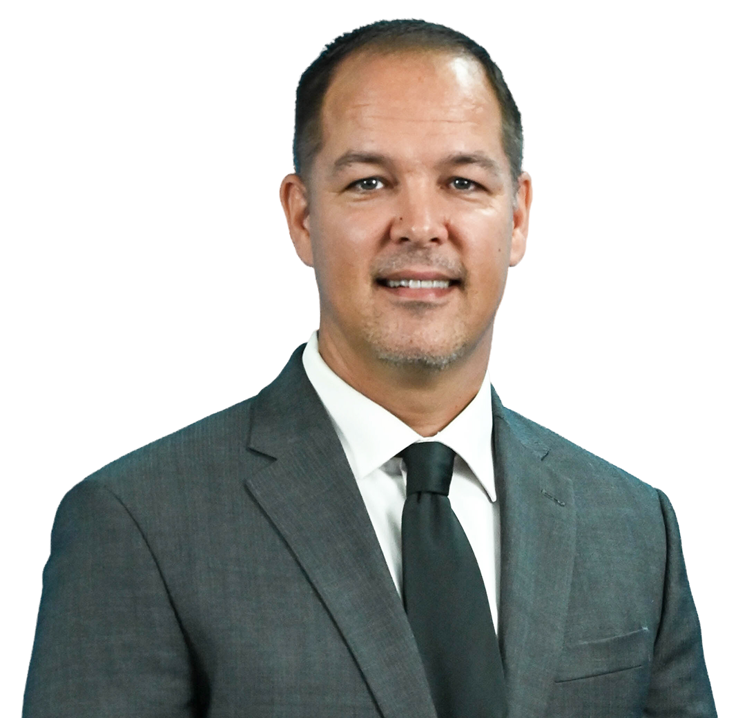 A man in a suit and tie is smiling for the camera