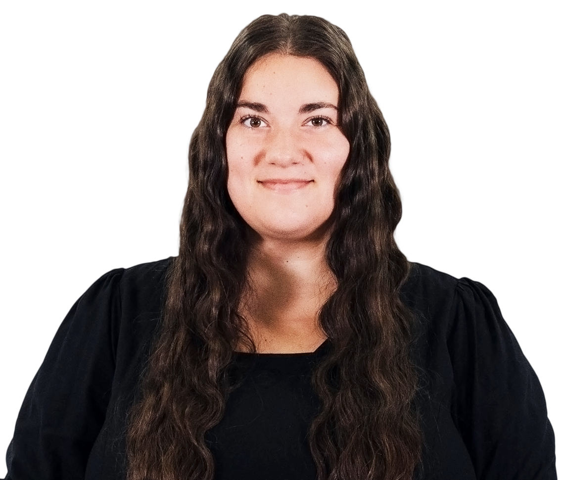 A woman with long hair is wearing a black shirt and smiling.