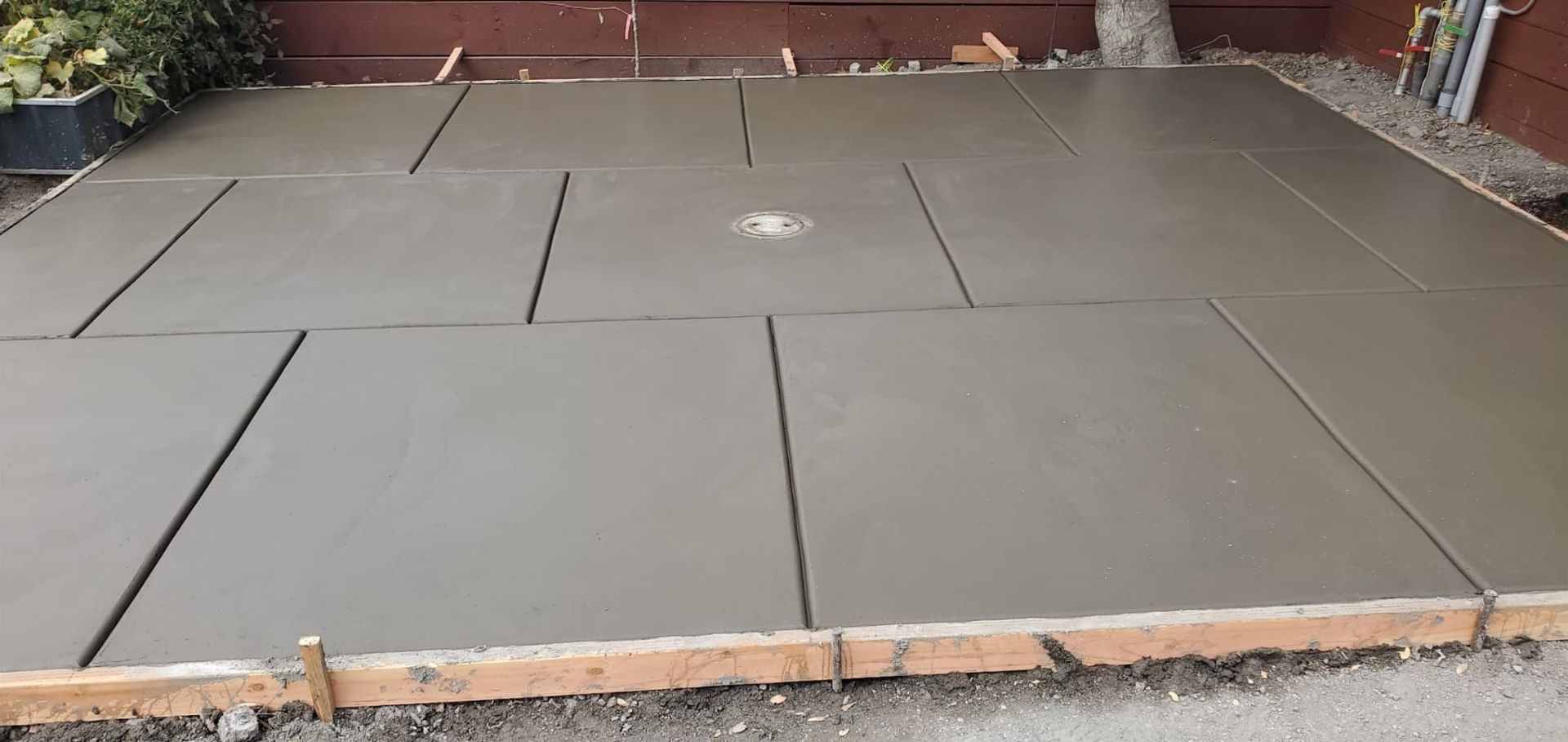 A concrete floor with a wooden frame around it is being built.