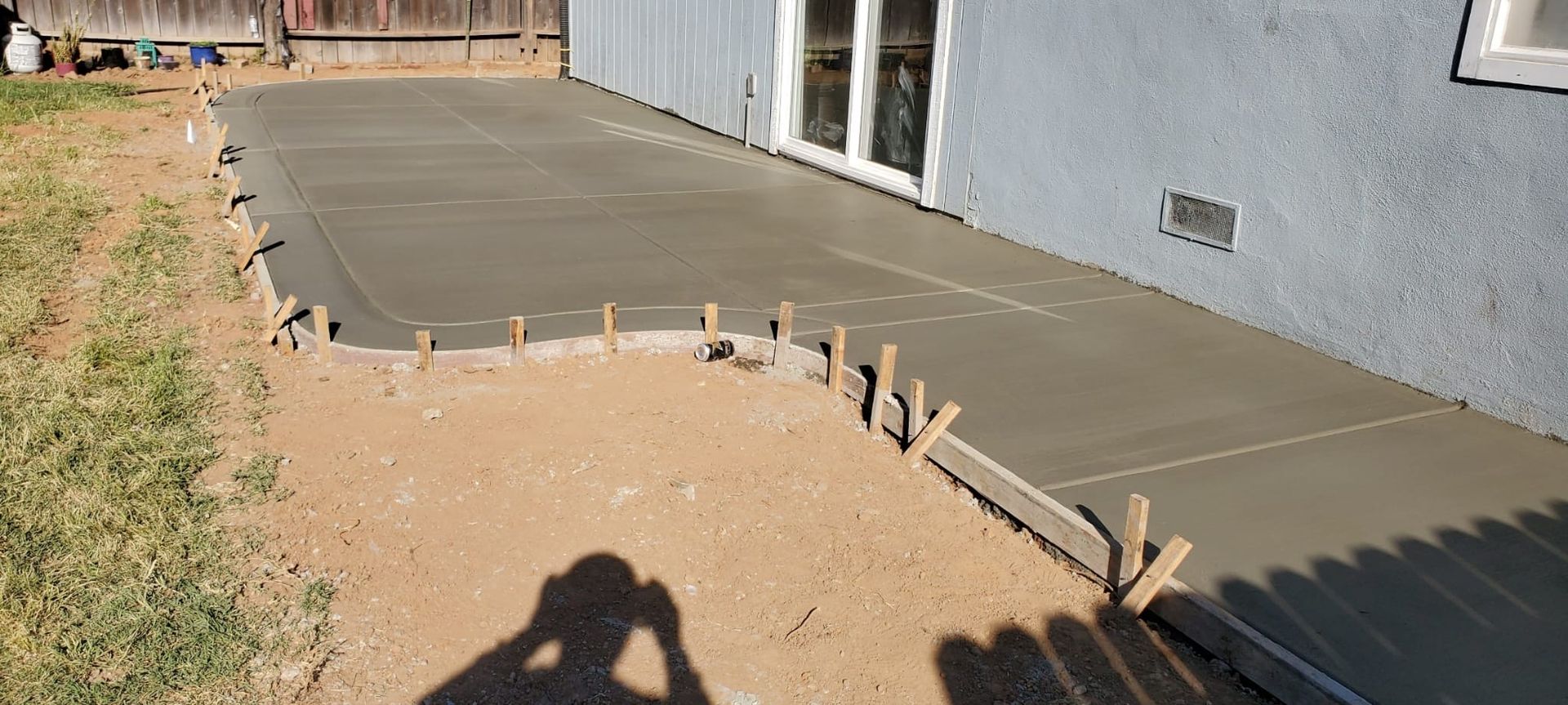 A concrete walkway is being built in a house.