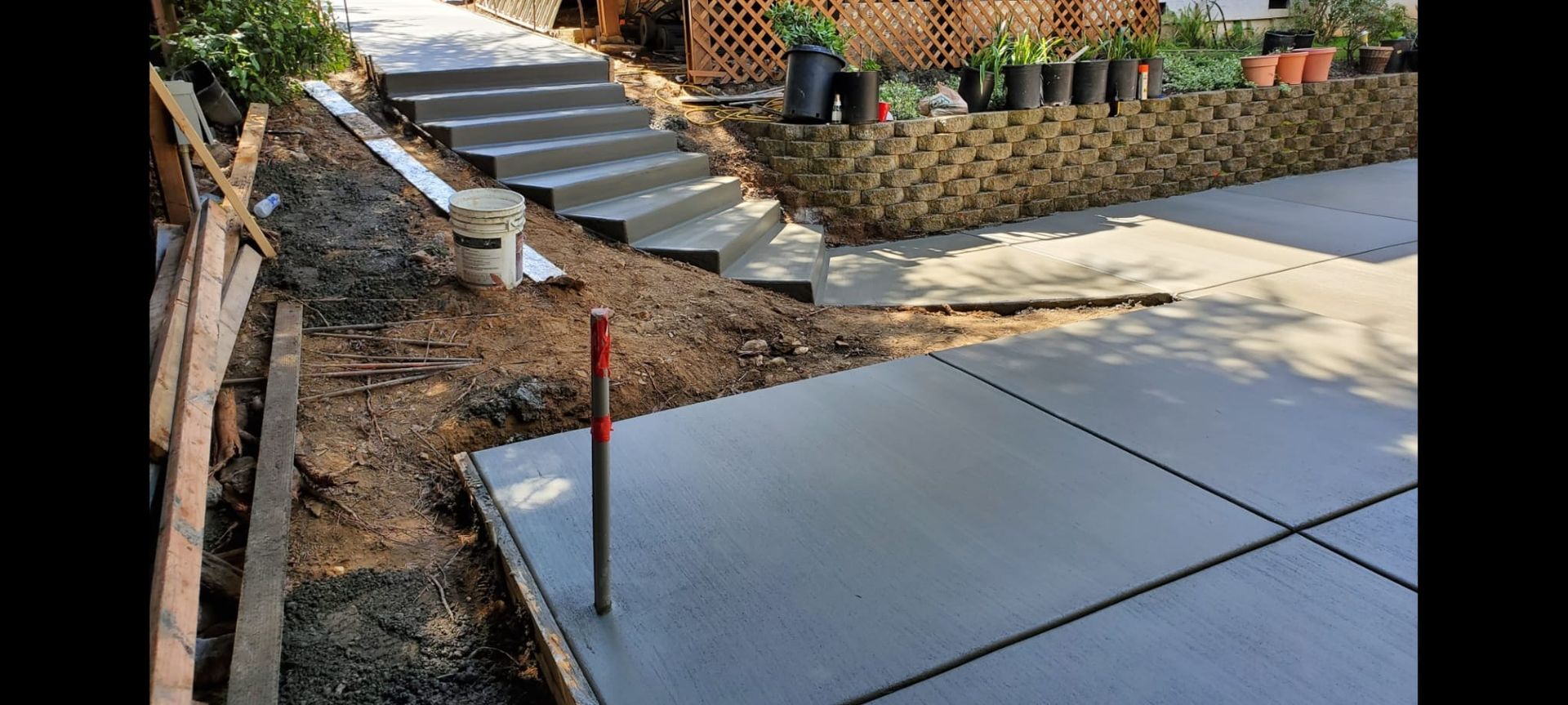 A concrete stair is being built in front of a house.