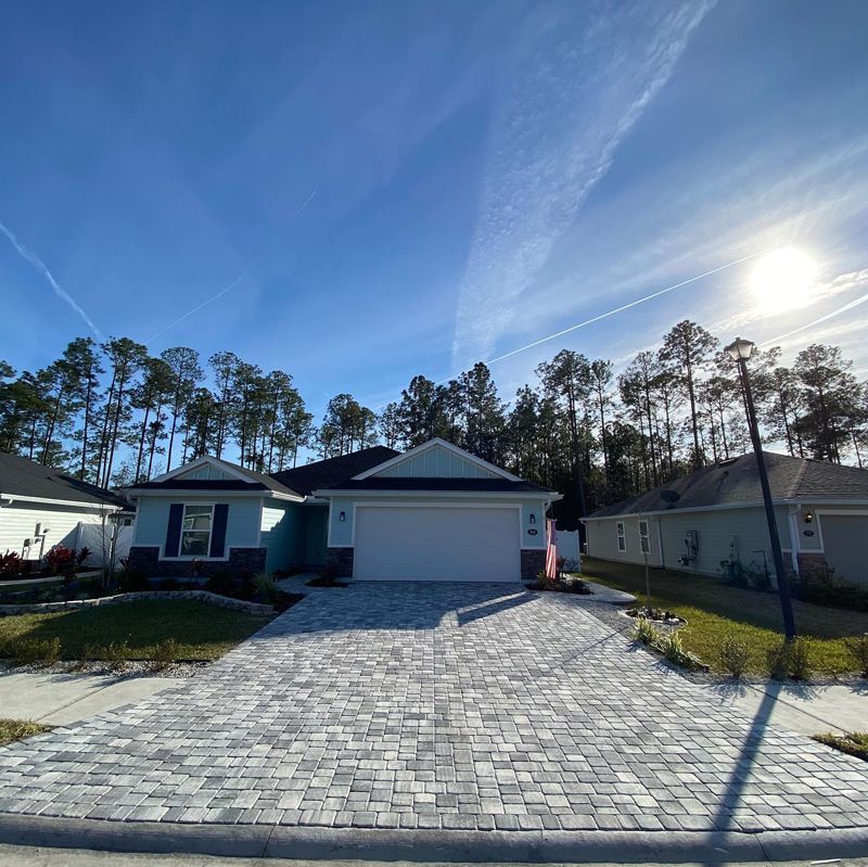 A house with a brick driveway in front of it