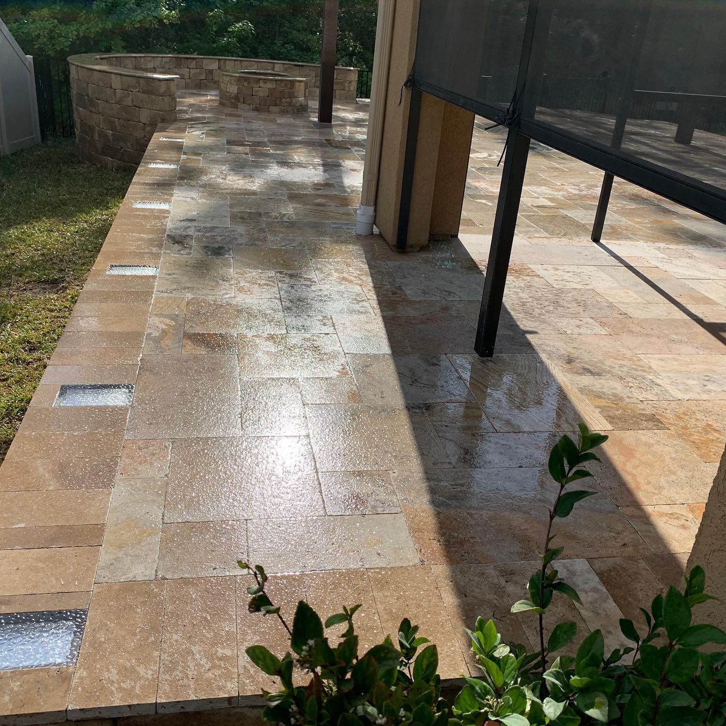 A tiled walkway leading to a screened in porch.