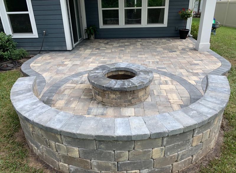 There is a fire pit in the middle of the patio.