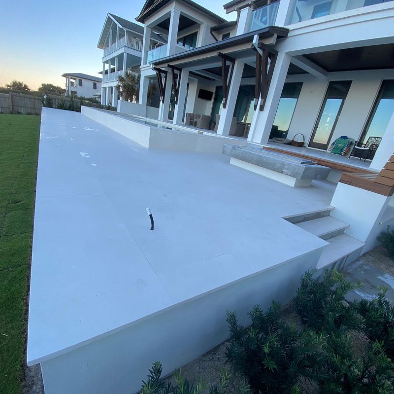 A large white house with a large patio in front of it