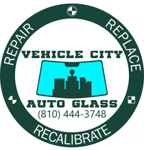 Vehicle City Auto Glass logo: windshield with city silhouette; teal and dark green colors; includes contact phone.