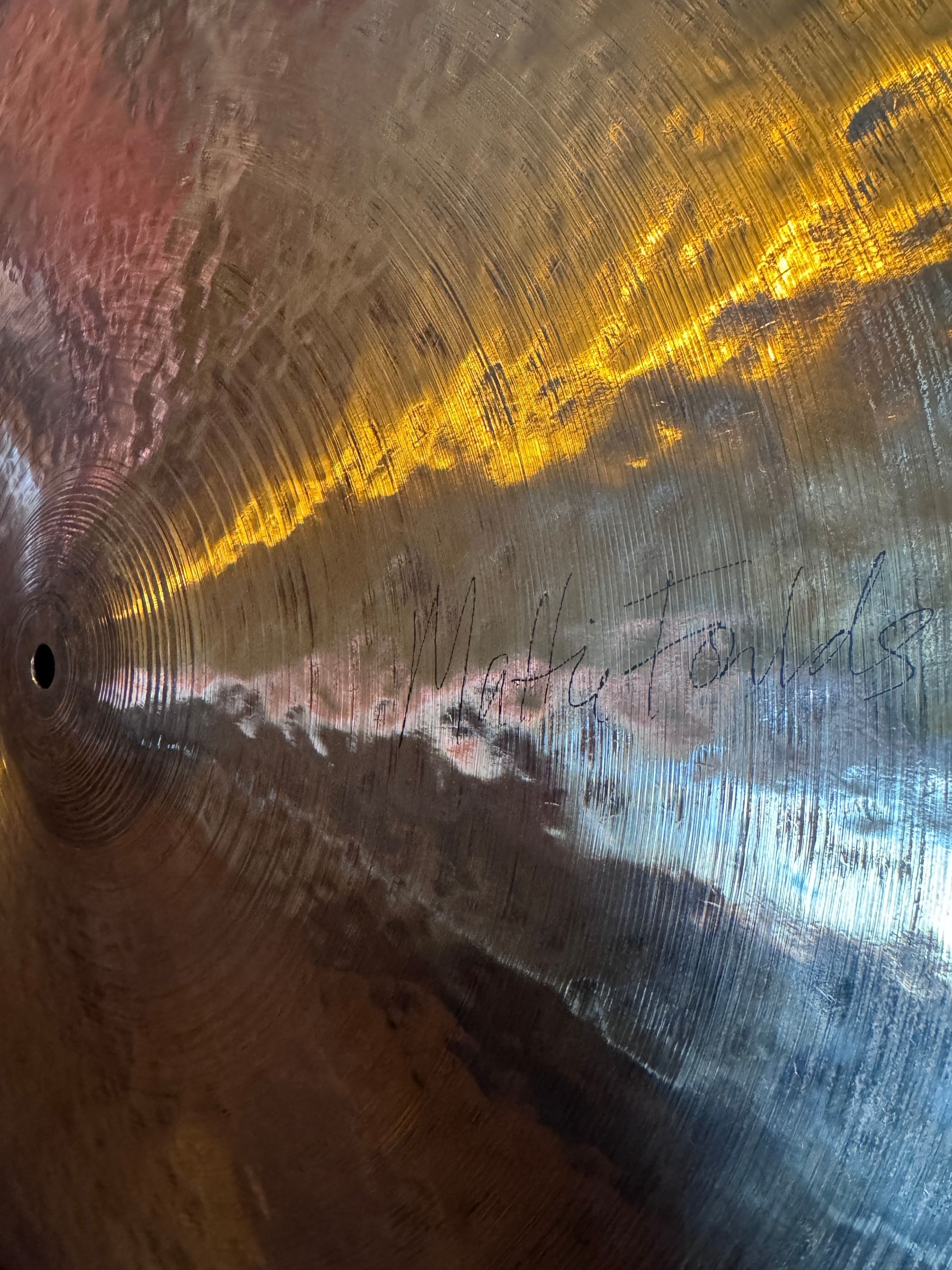 Abstract view of a reflective surface with gold and gray hues.