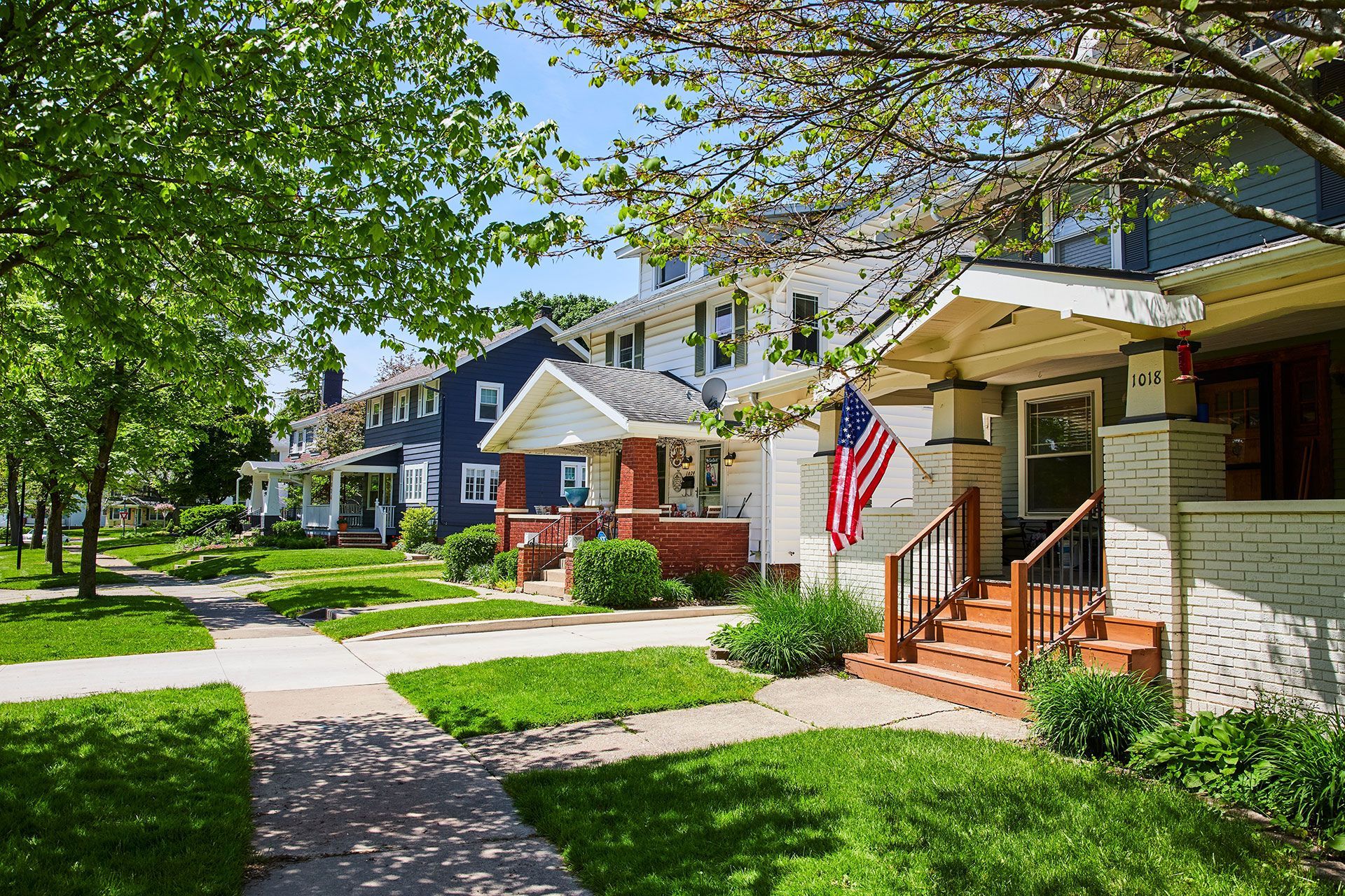 A row of houses with a flag on the front of one of them.