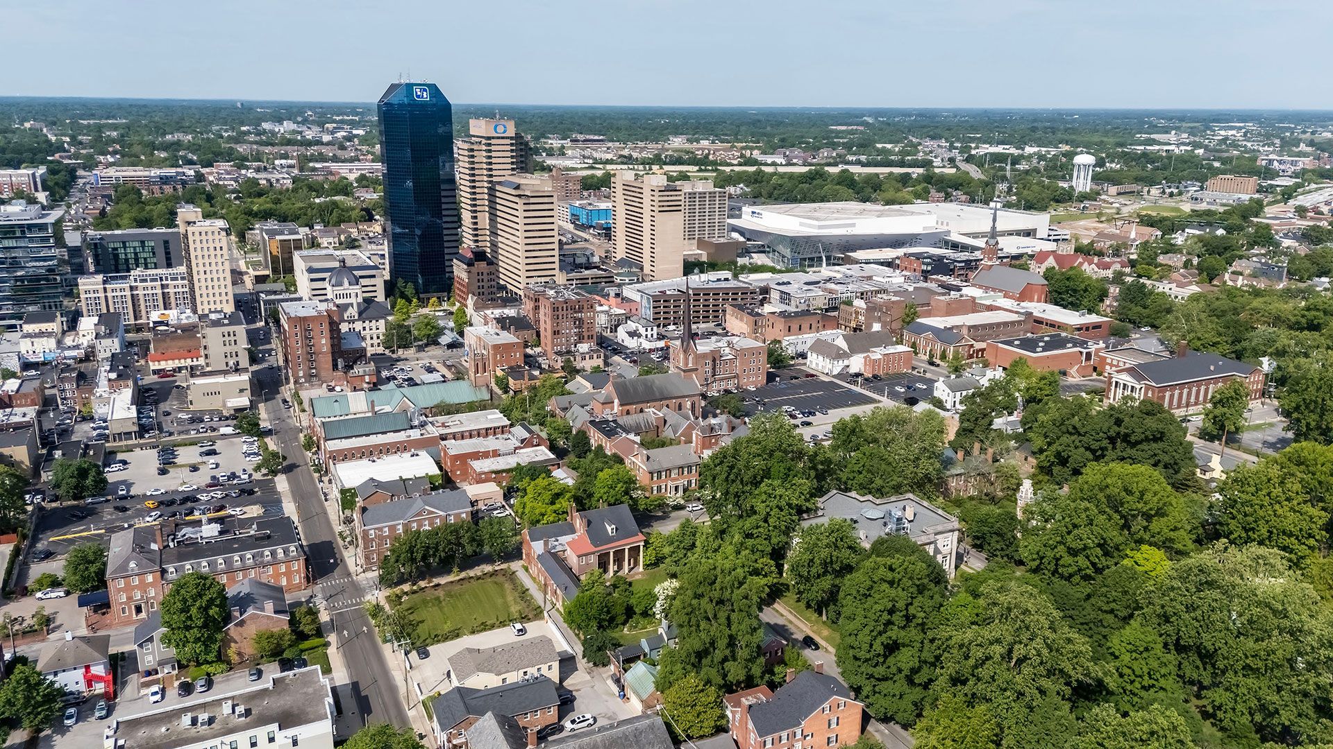 An aerial view of a city surrounded by trees and buildings.