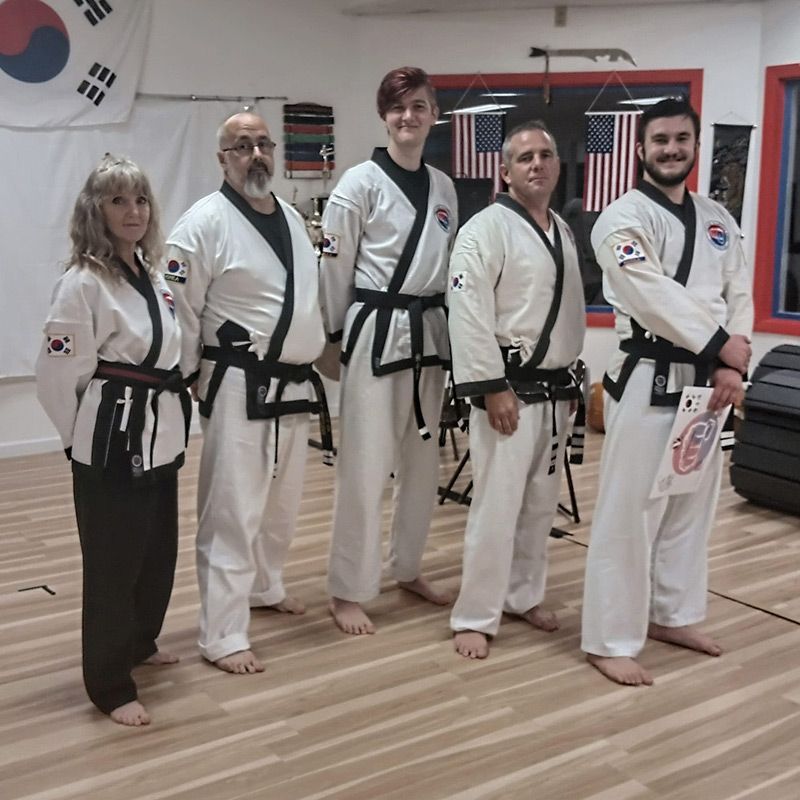 A group of martial arts fighters pose for a picture