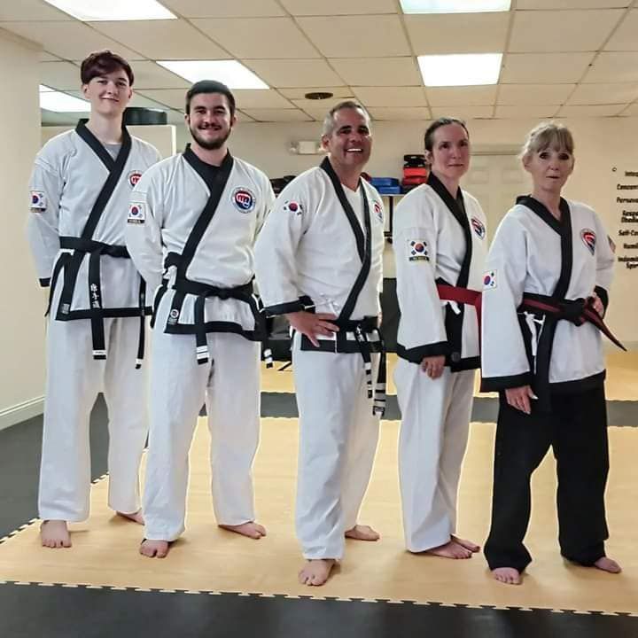 A group of martial arts fighters are posing for a picture
