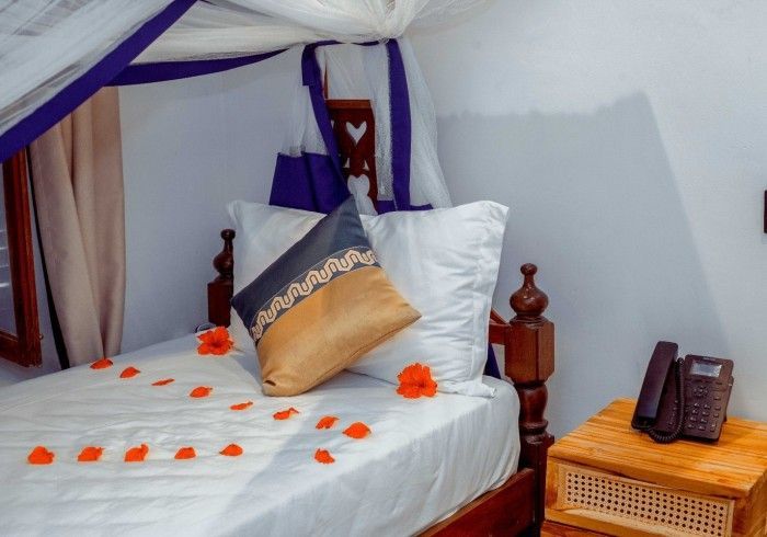 A bed with a canopy and flowers on it