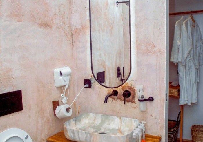 A bathroom with a sink , toilet and mirror.