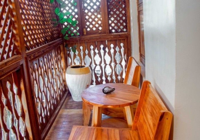 There is a table and chairs on the balcony.