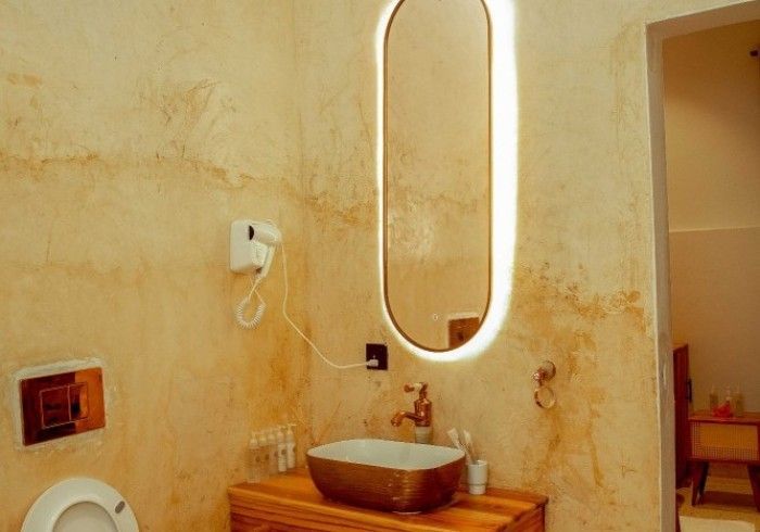 A bathroom with a sink , toilet and mirror.