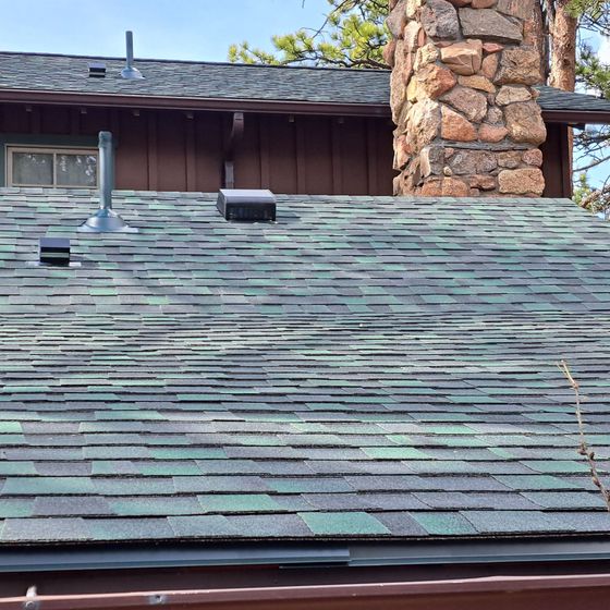 The roof of a house with a chimney on it