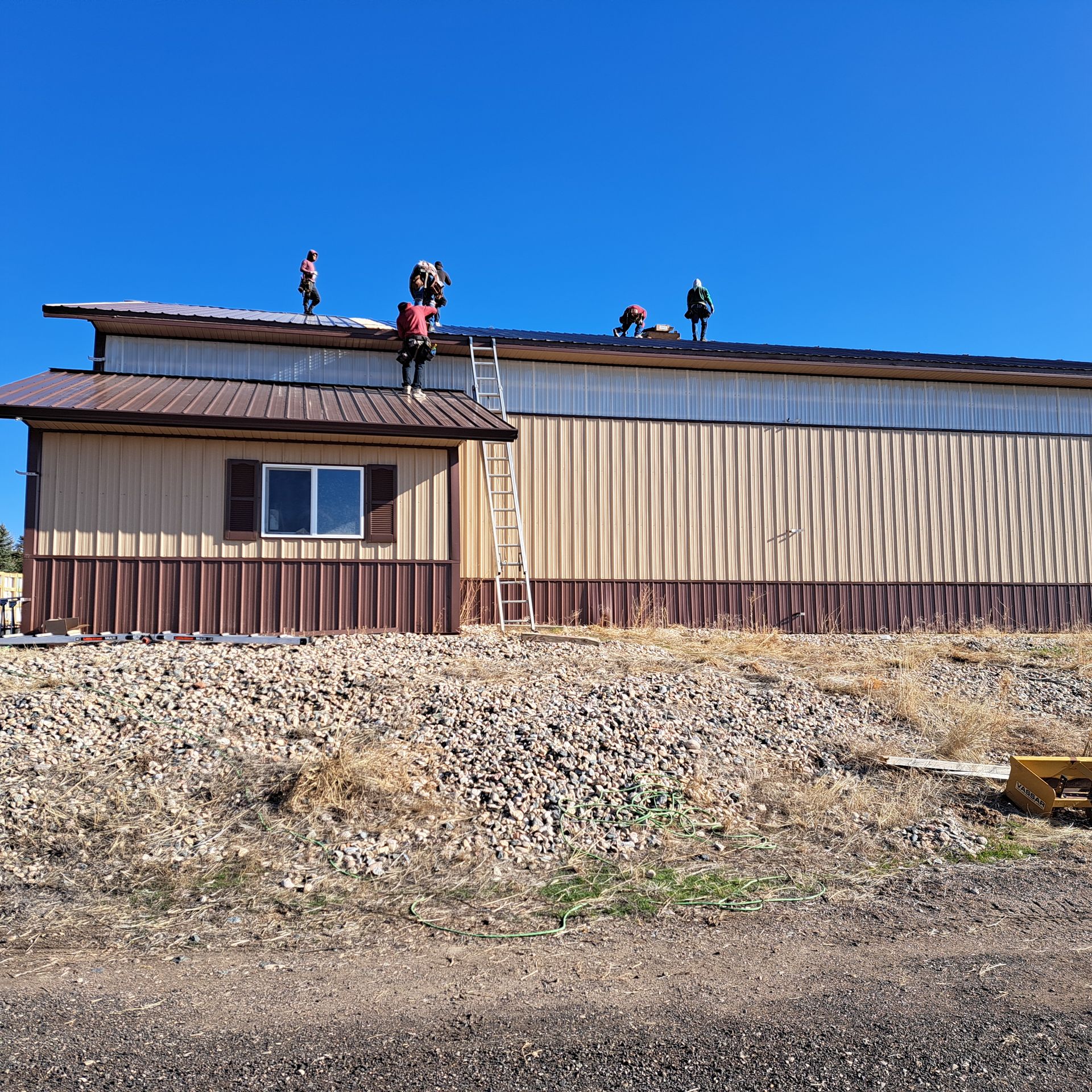 A group of people are working on the roof of a building