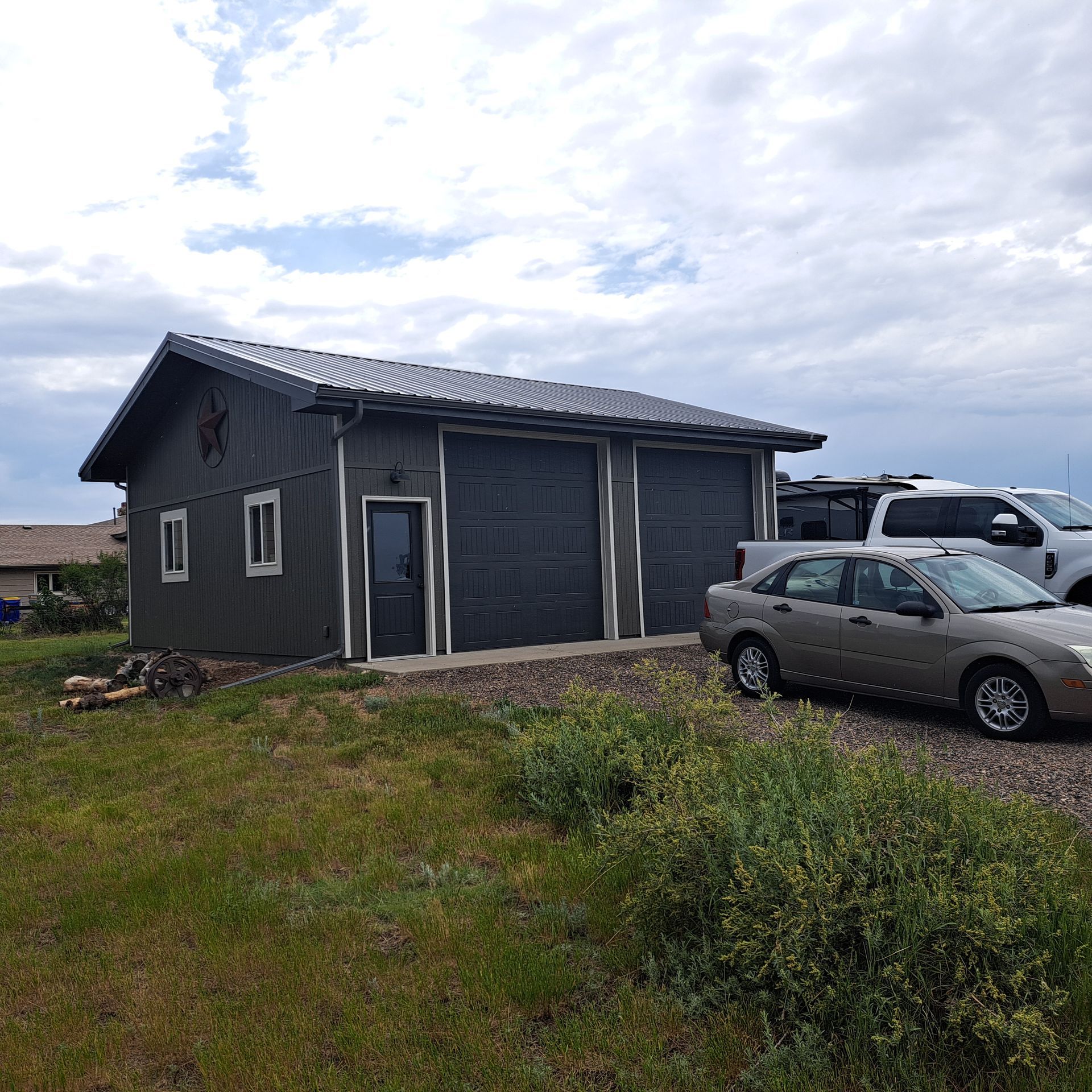 A car is parked in front of a garage.