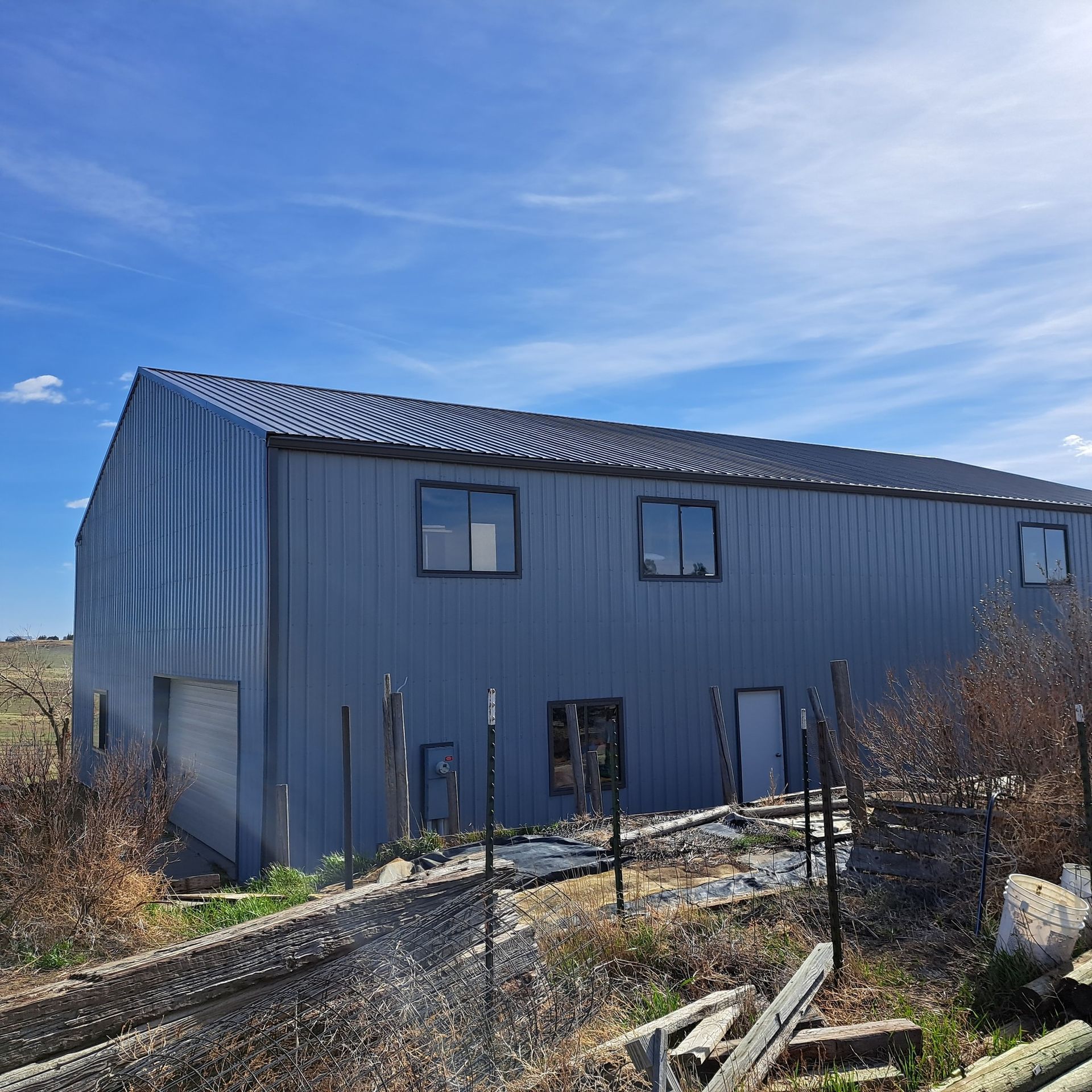 A large gray building with a blue sky in the background