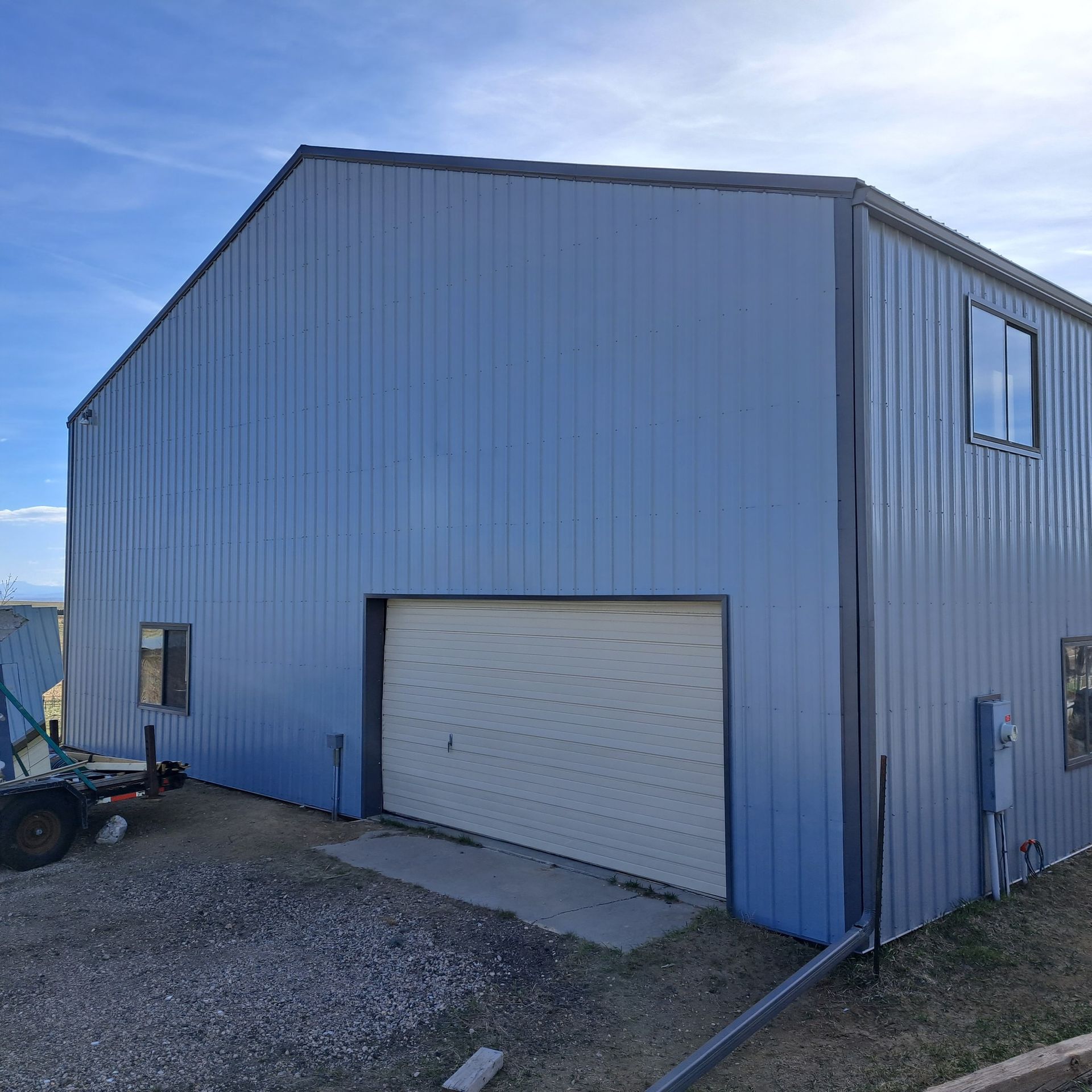 A blue building with a white garage door