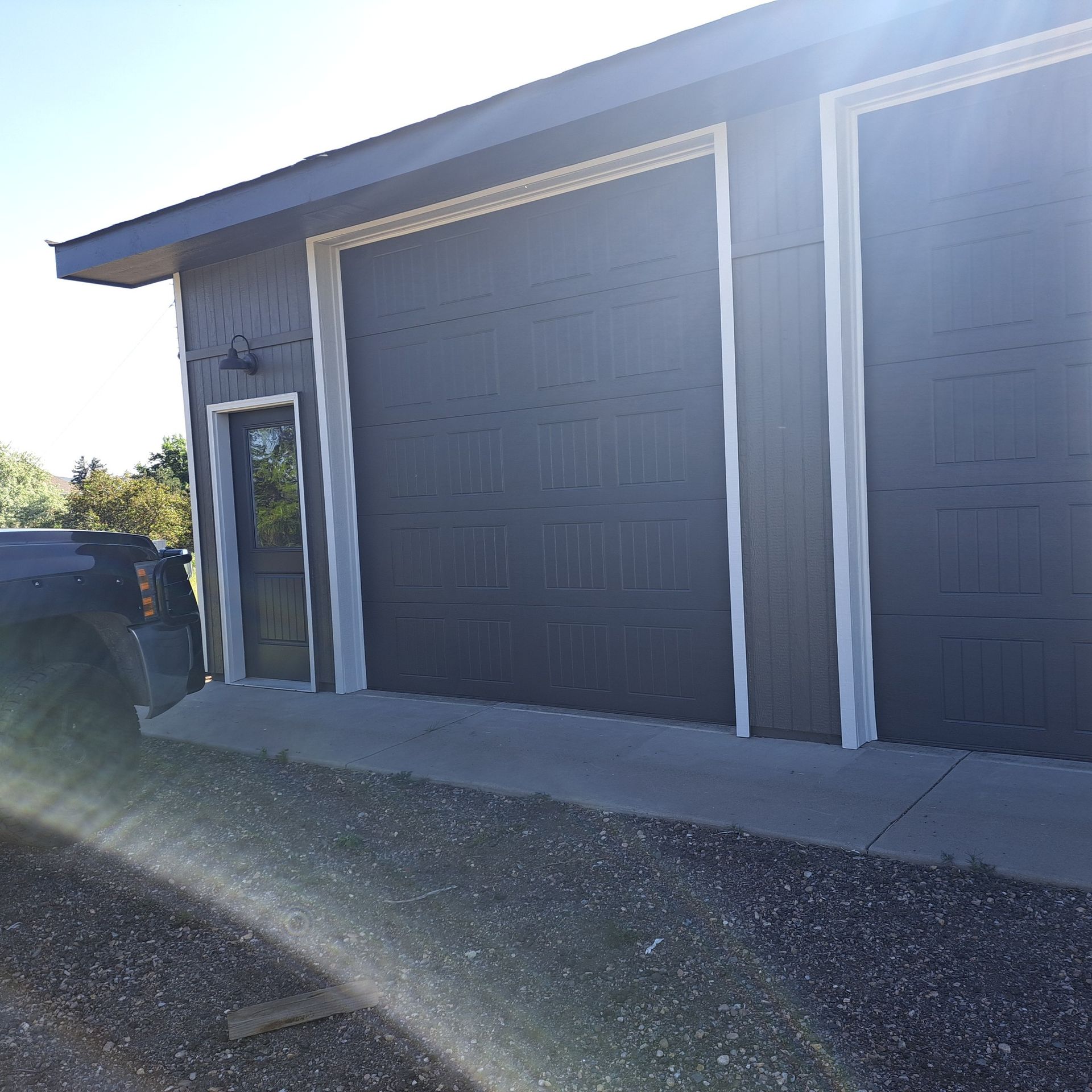A car is parked in front of a garage door