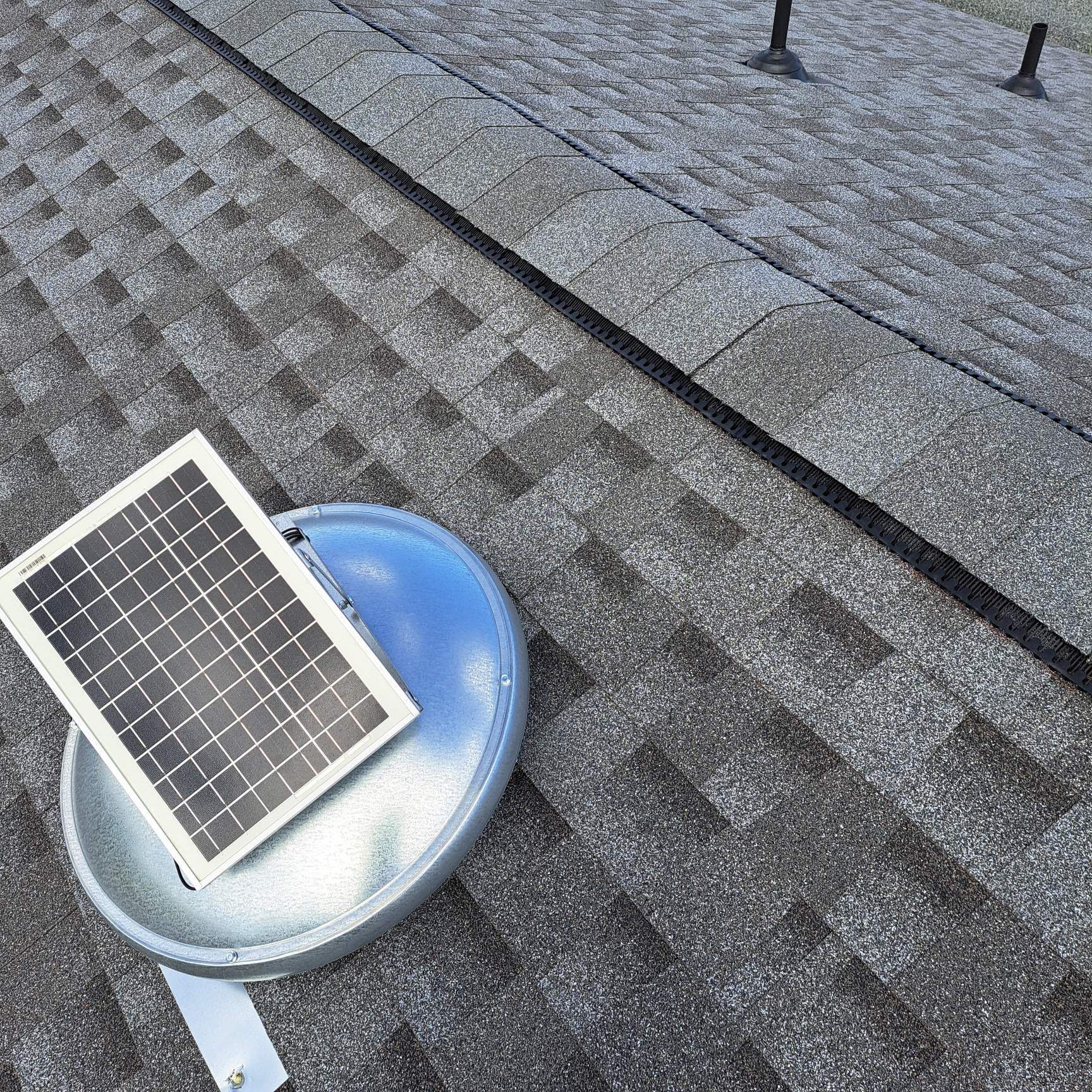 A solar panel is sitting on top of a roof.