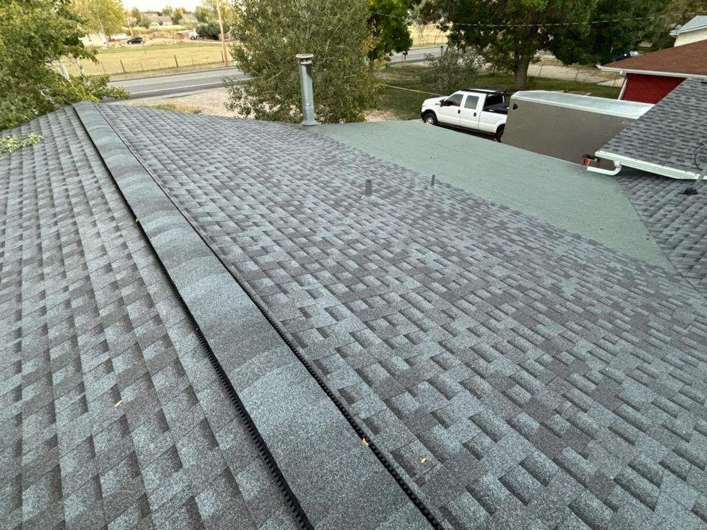 A white truck is parked on the roof of a house.