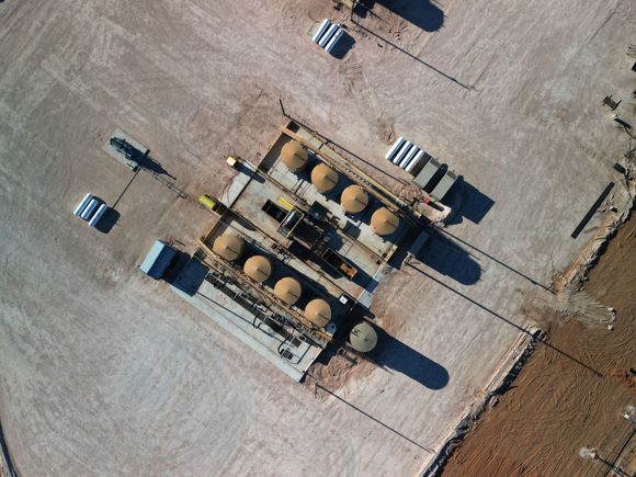 An aerial view of a gas station in the desert