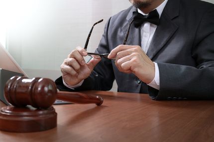 man holding his glasses