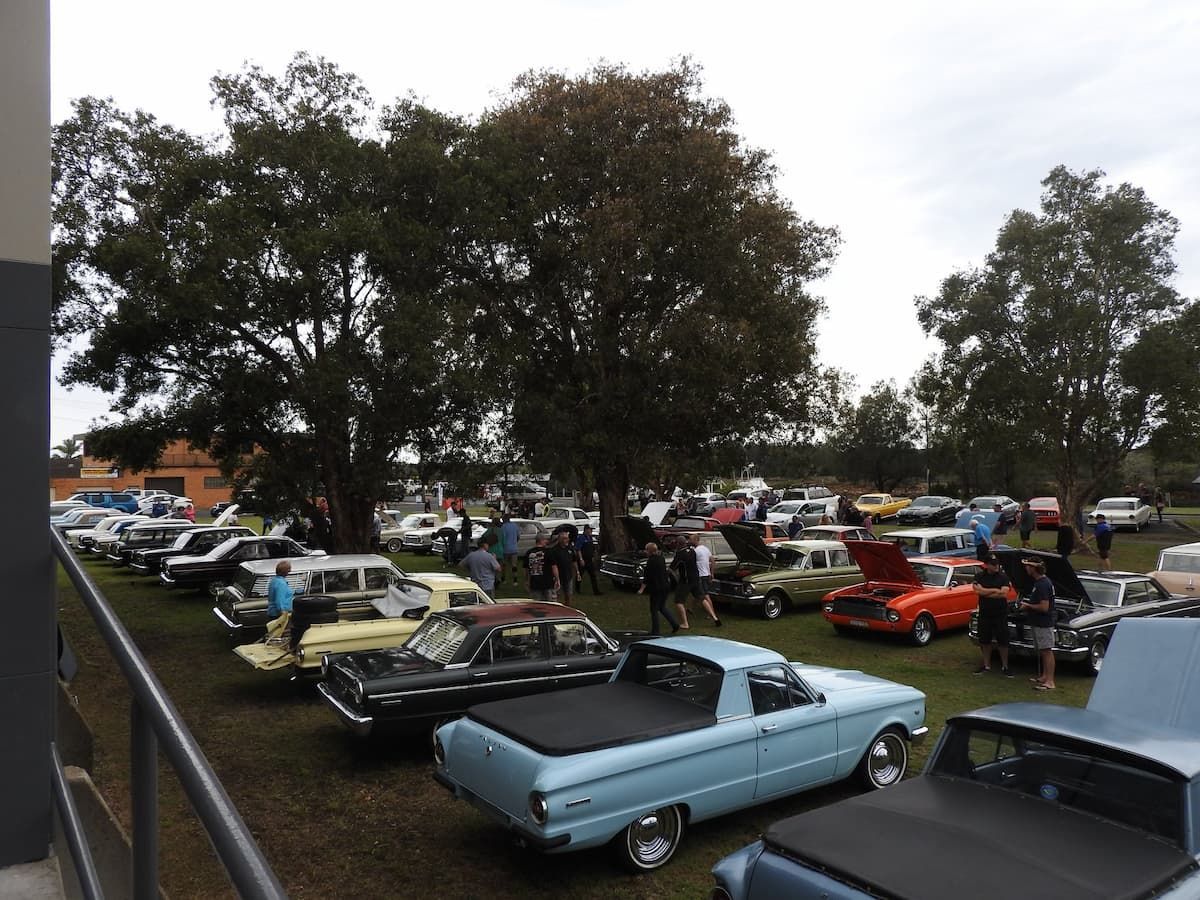 A Lot Of Cars Are Parked In A Grassy Area — Woongarra Motel In North Haven, NSW