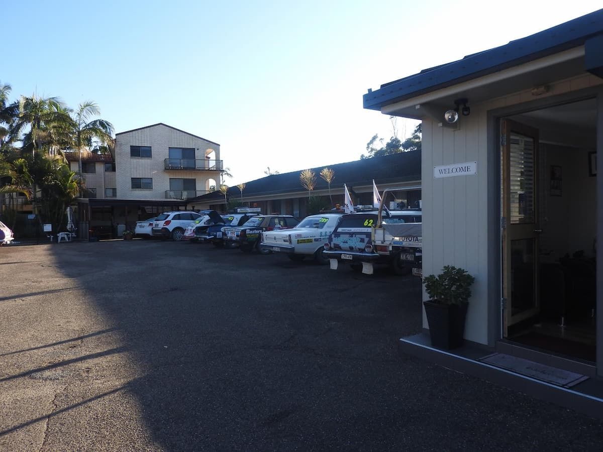 A Row Of Cars Are Parked In Front Of A Motel — Woongarra Motel In North Haven, NSW