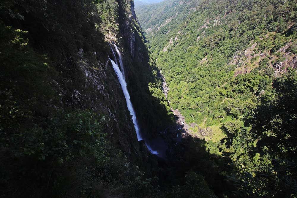 A Waterfall In The Middle Of A Valley Surrounded By Trees β Woongarra Motel In North Haven, NSW