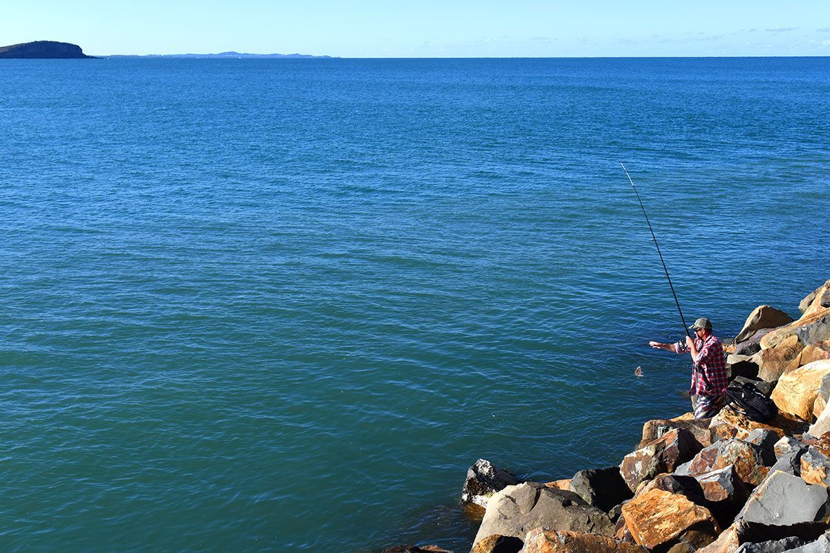 A Man is Fishing Of Some Rocks β Woongarra Motel In North Haven, NSW