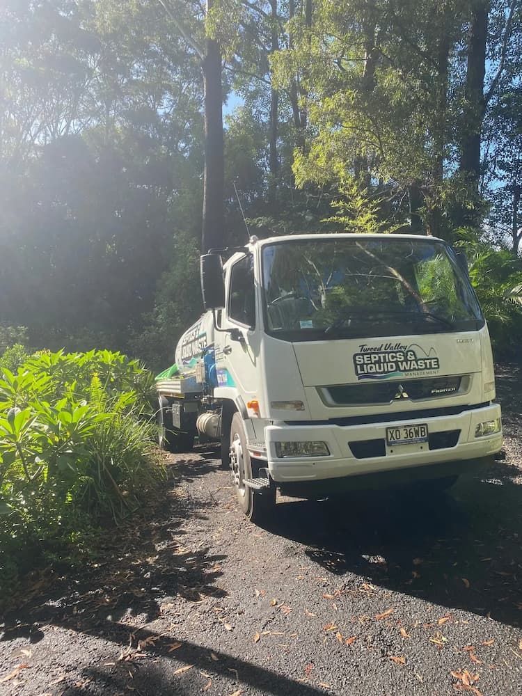 White Truck is Parked on the Side of a Dirt Road — Tweed Valley Septics & Liquid Waste Management in South Murwillumbah, NSW
