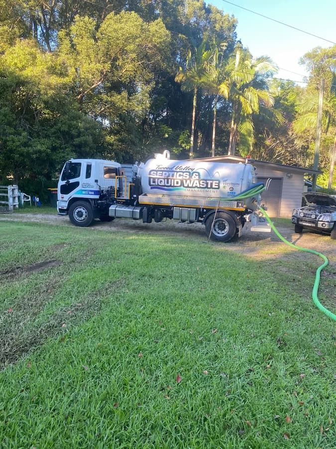 Large Truck is Parked in a Grassy Field  — Tweed Valley Septics & Liquid Waste Management in South Murwillumbah, NSW