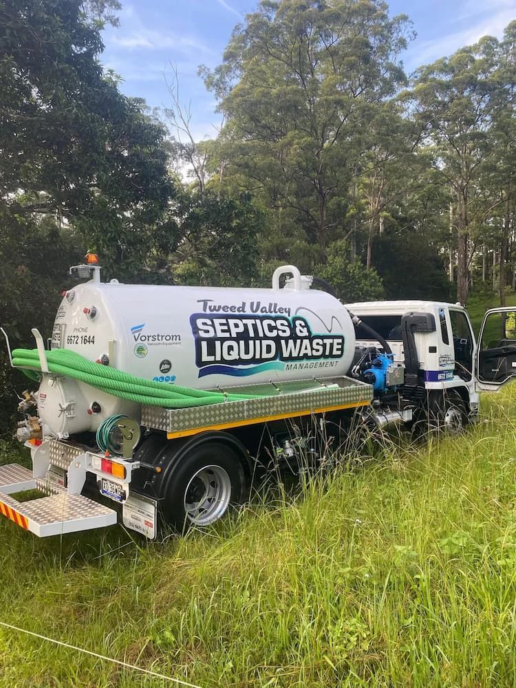 Septic Tank Truck is Parked in a Grassy Field — Tweed Valley Septics & Liquid Waste Management in South Murwillumbah, NSW