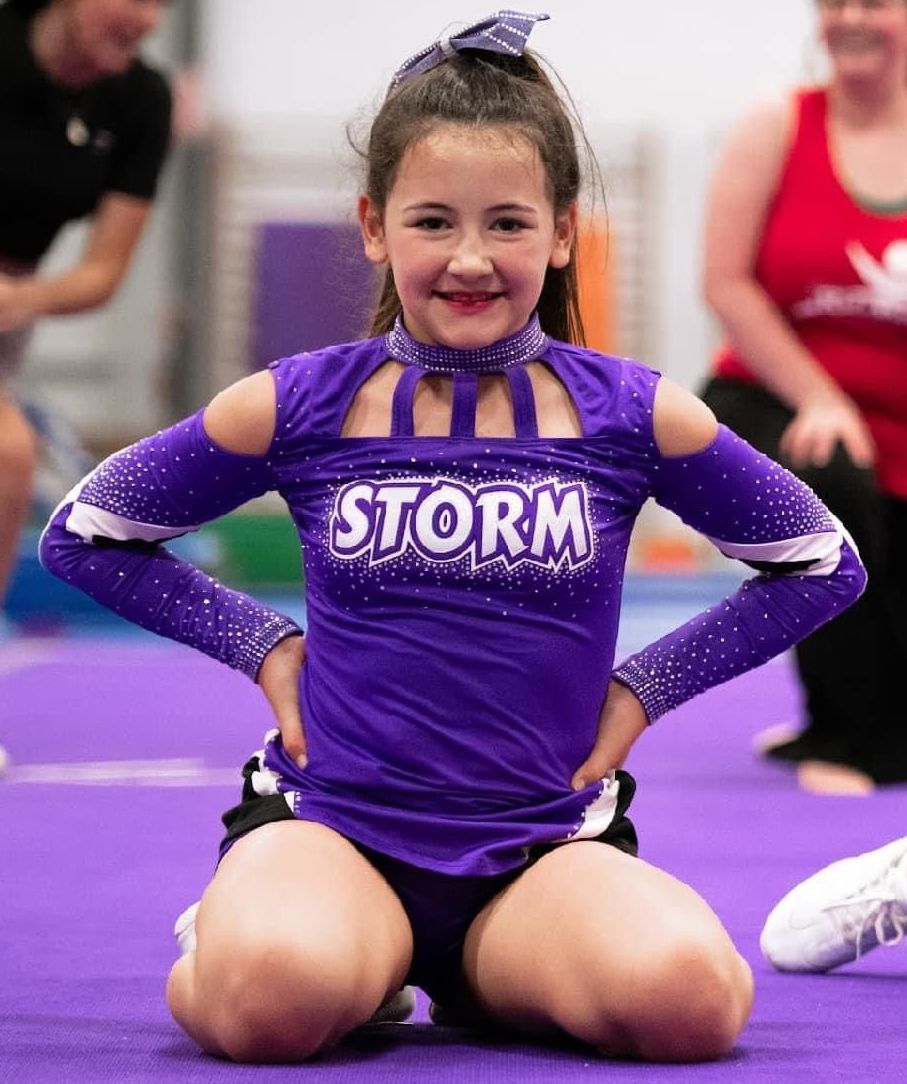 Young cheerleader smiling in pose