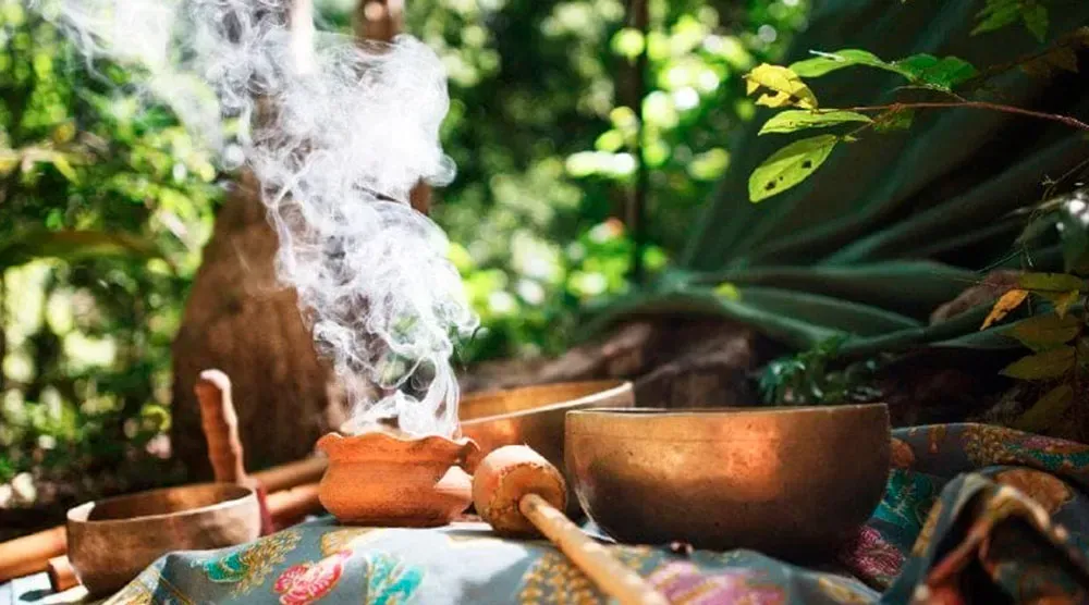 A group of bowls sitting on top of a table with smoke coming out of them.