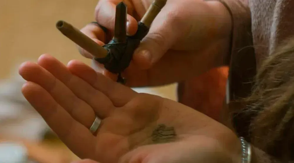 A person is holding a pair of scissors in their hand.