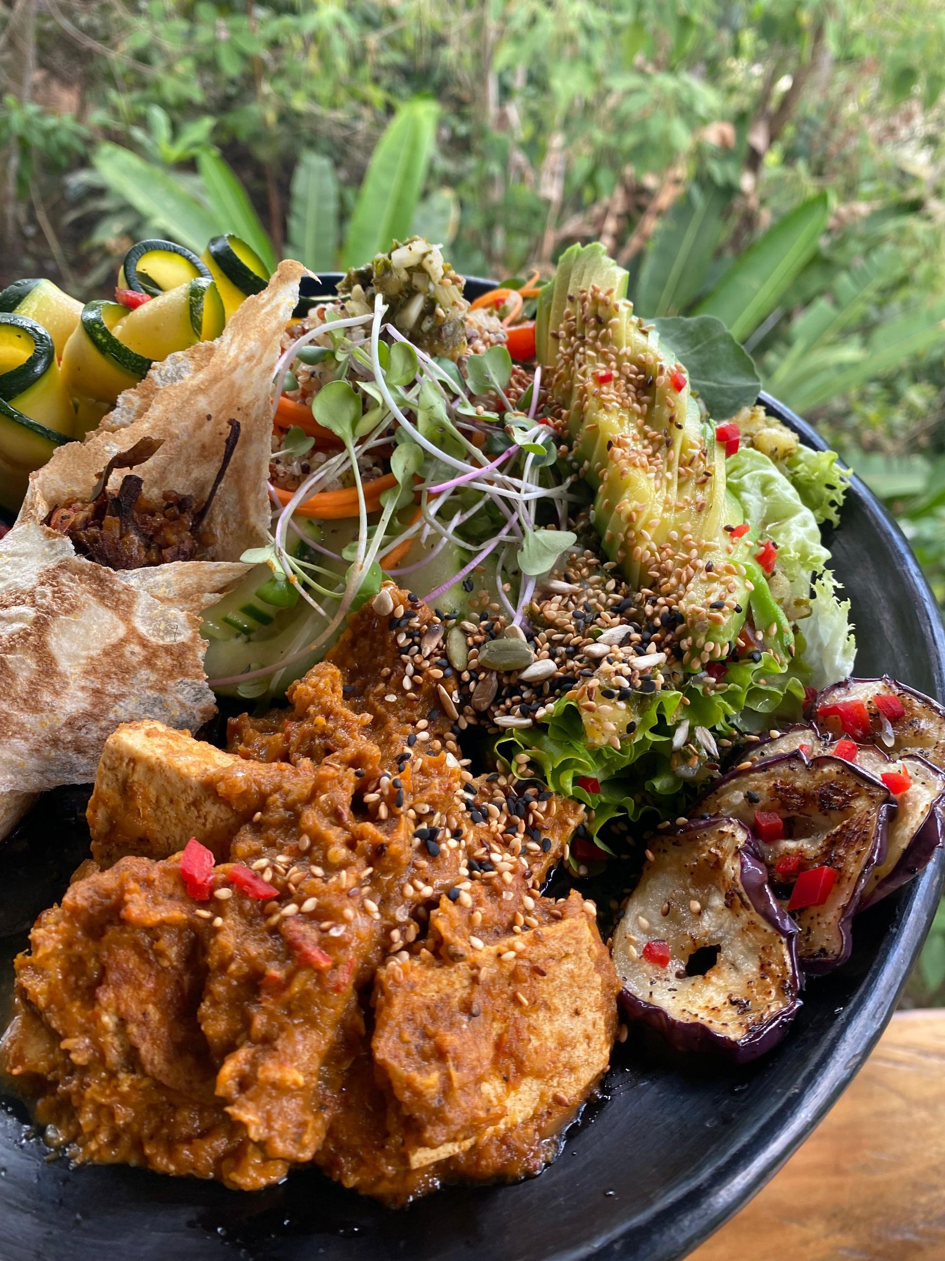 A plate of food with vegetables and meat on a table.