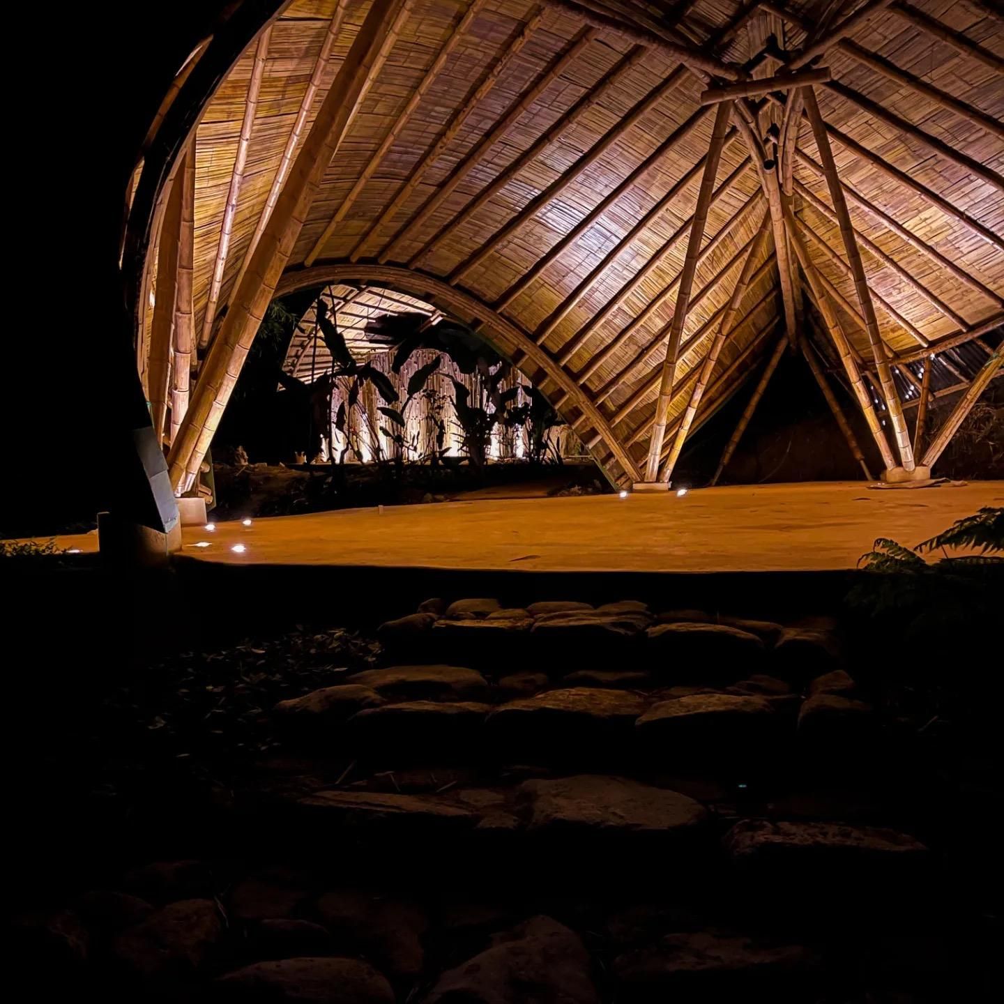 A large wooden structure is lit up at night.