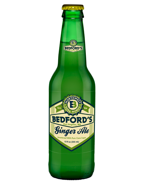 A green bottle of bedford 's ginger ale on a white background